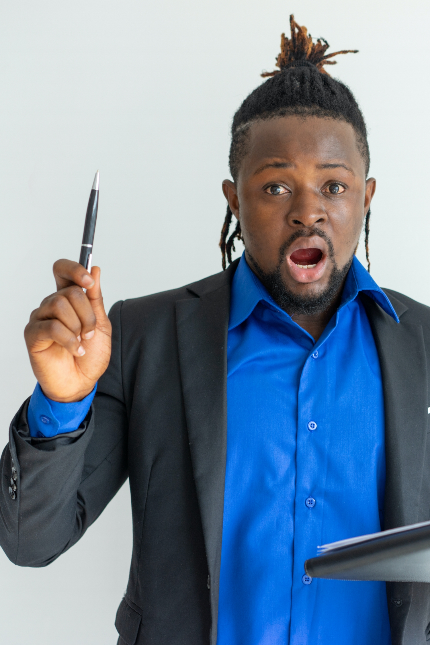 Shocked hipster businessman holding pen up while having idea