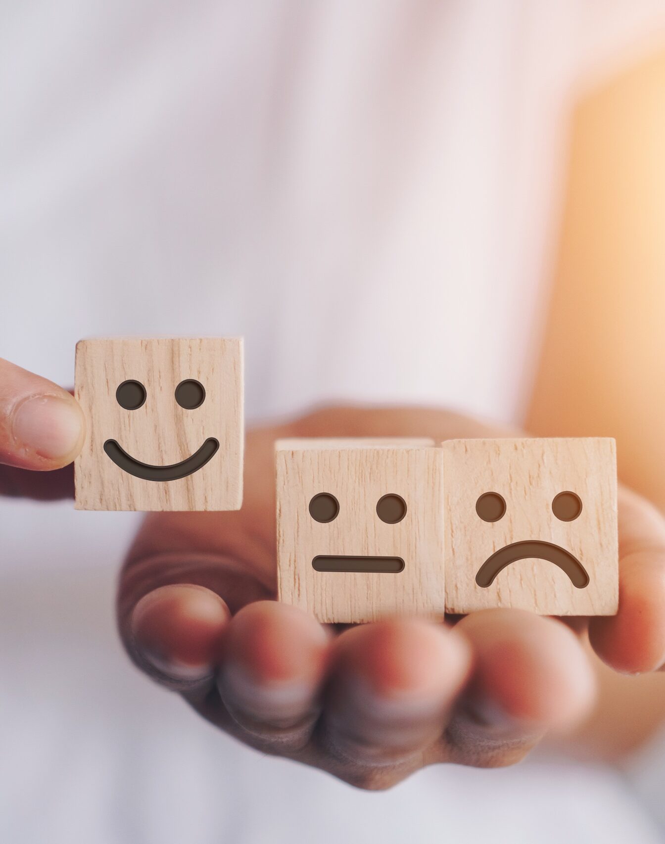 Smile face and cart icon on wood cube. Optimistic person or people feeling inside and service rating when shopping, satisfaction concept.